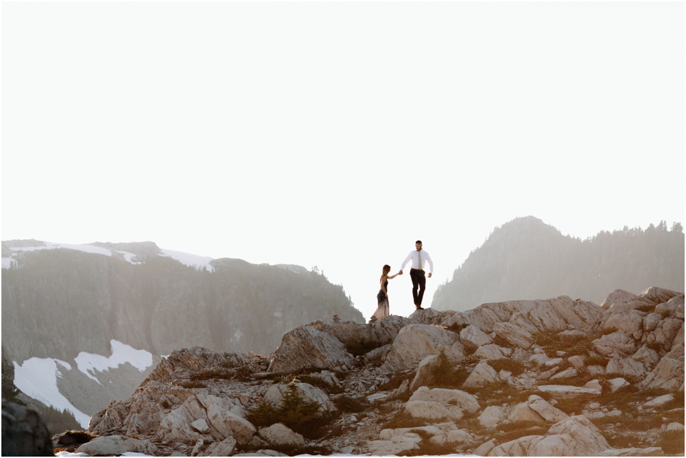 bride and groom walk along rocks Artist Point hiking engagement