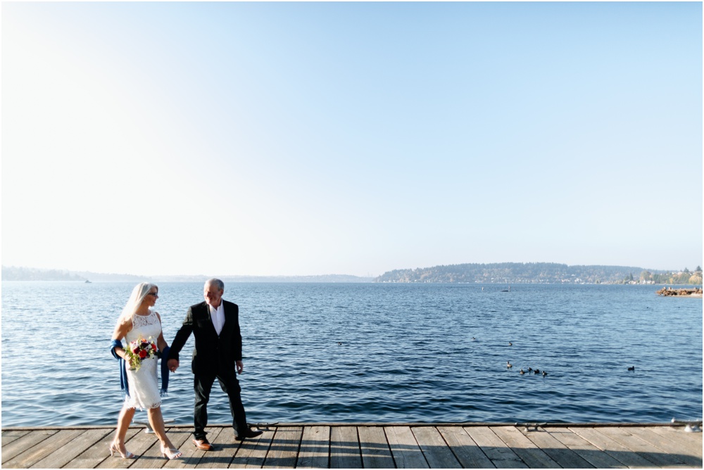 couple walks along water Hyatt Regency Lake Washington