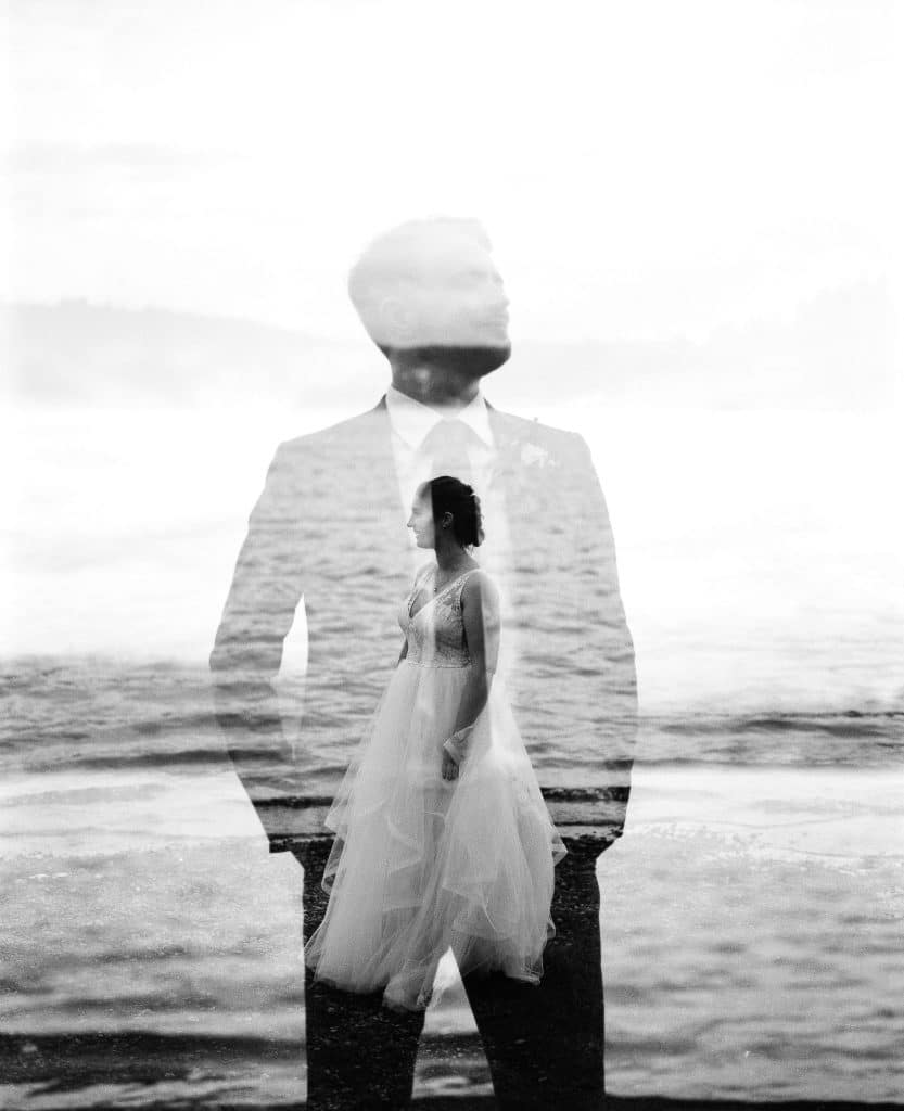 double exposure of bride and groom on black and white film during backyard elopement at sunset