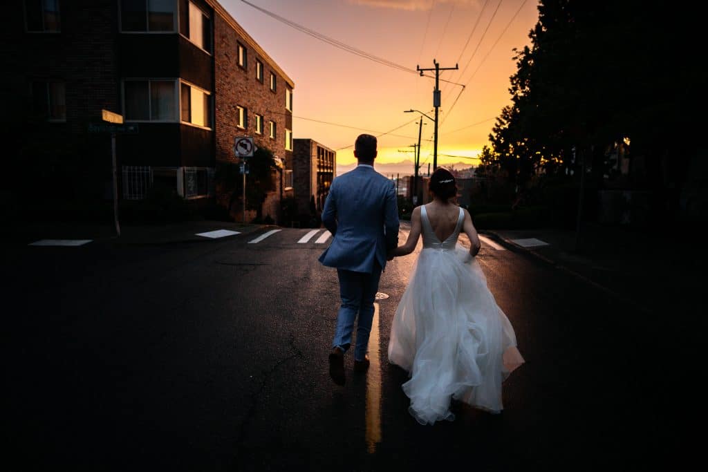 bride and groom run off into sunset during seattle wedding