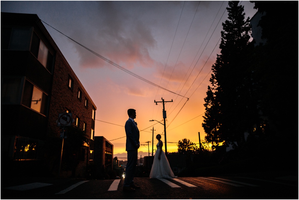 bride and groom stand in sunset ranier chapter house wedding