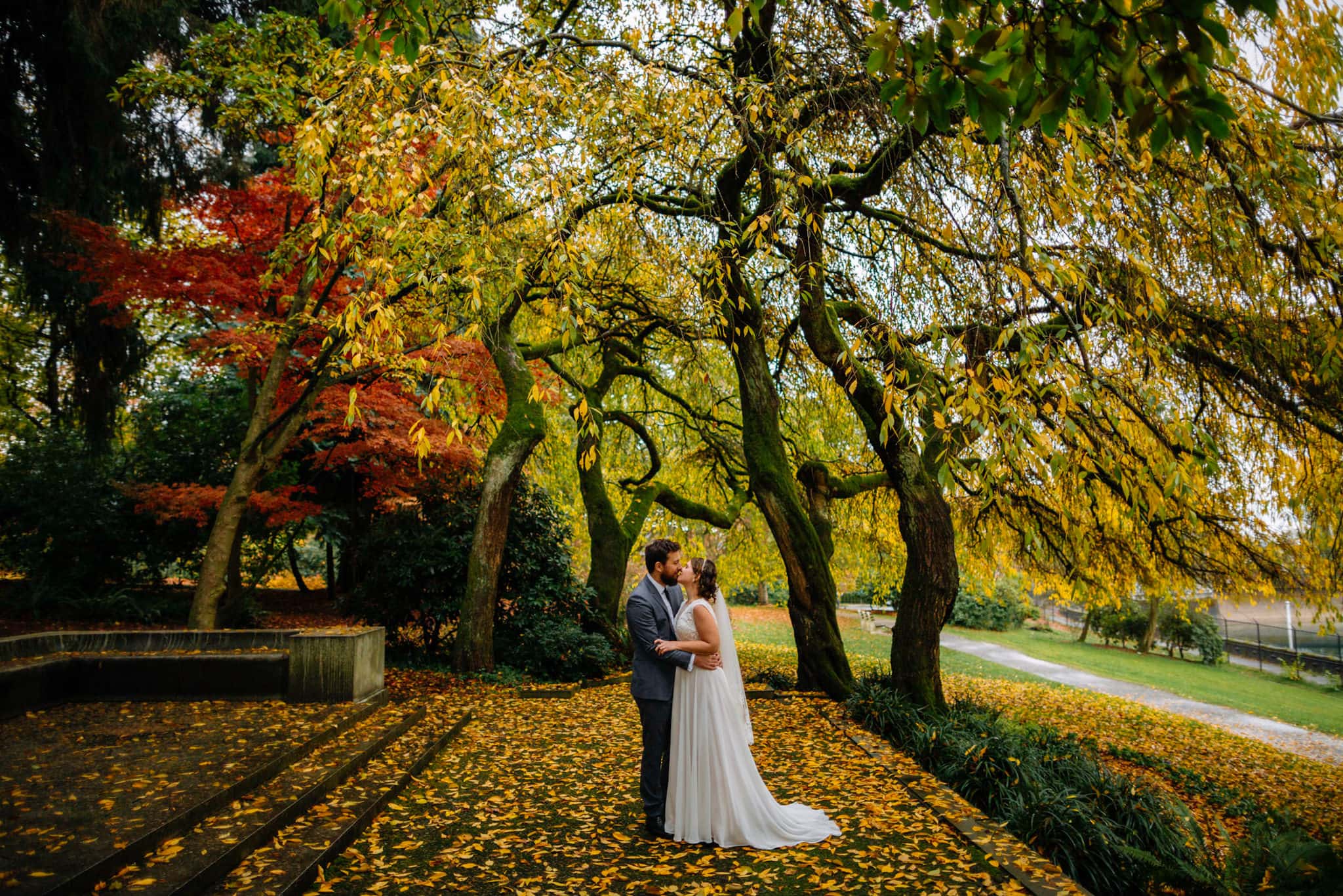 bride groom kiss under leaves
