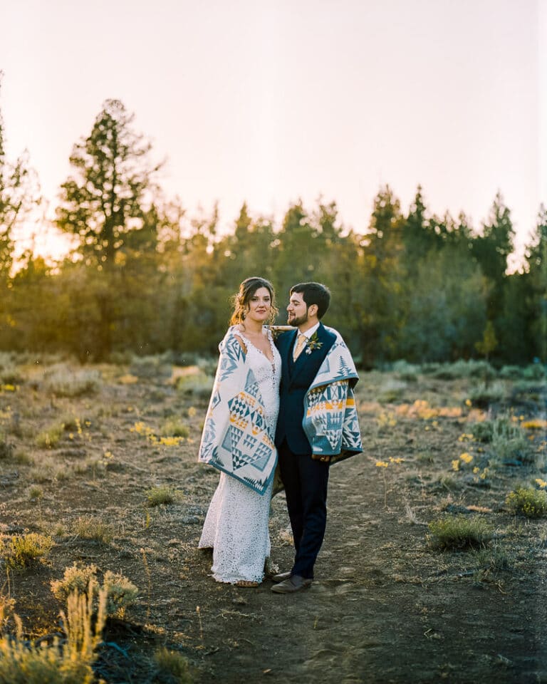 bride and groom stand together mt rainier