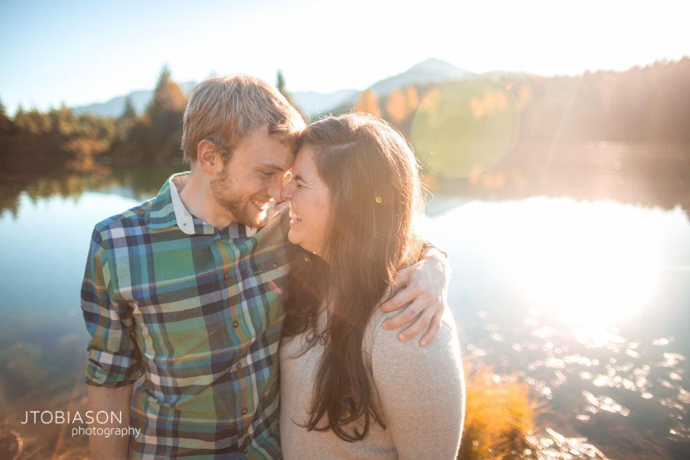 Man and woman laugh in the sunset snoqualmie pass engagement