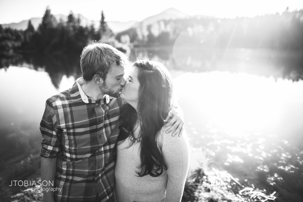 Man and woman kiss in the sunset snoqualmie pass engagement