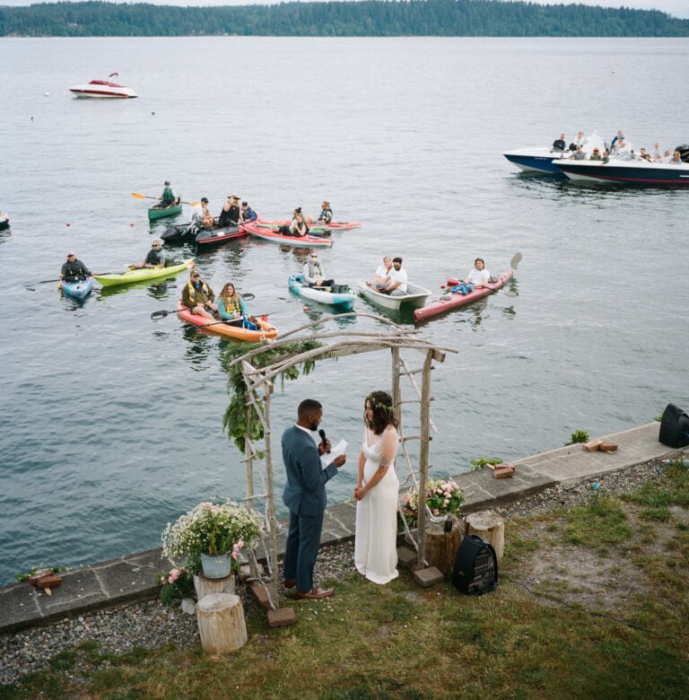 groom reads vows during floating COVID elopement